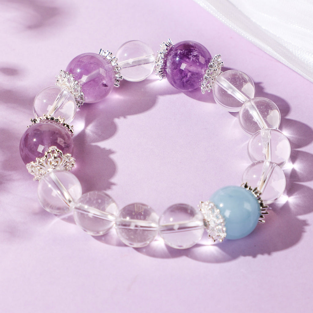 Minimalist crystal bracelet with three purple beads and one blue bead