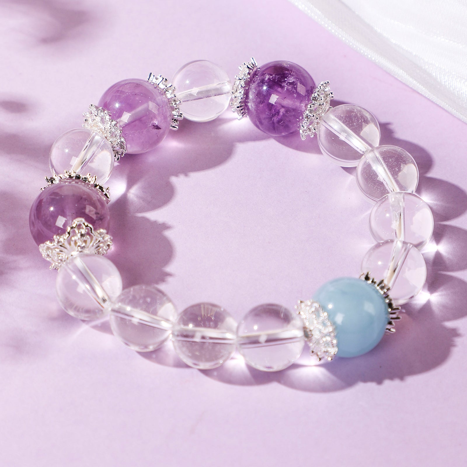 Minimalist crystal bracelet with three purple beads and one blue bead