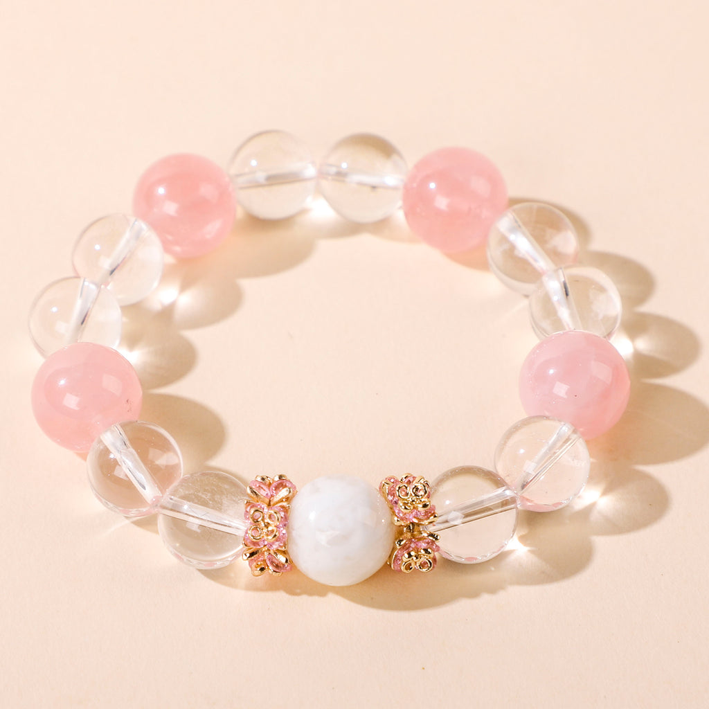 Minimalist bracelet featuring four pink beads and white crystal beads