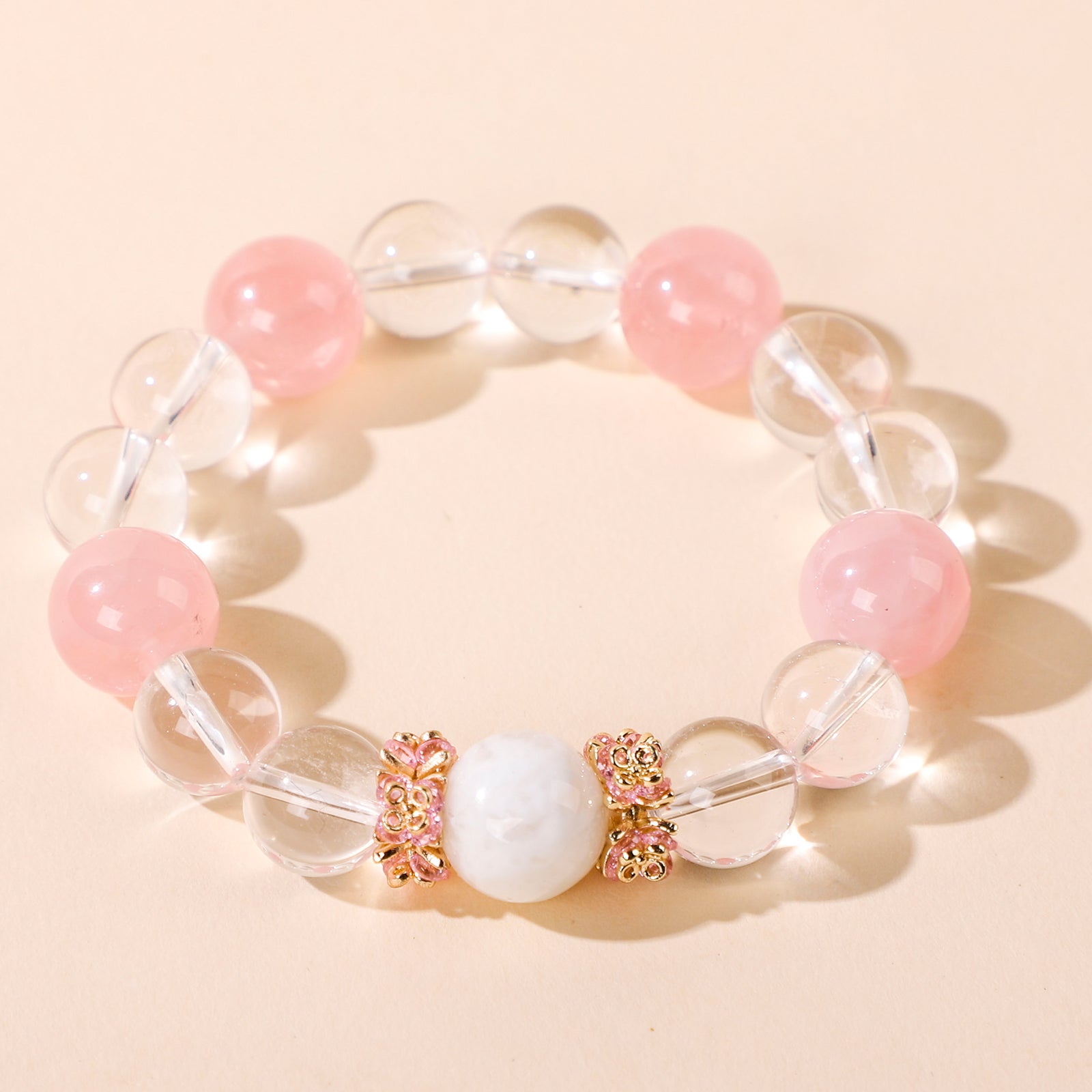 Minimalist bracelet featuring four pink beads and white crystal beads
