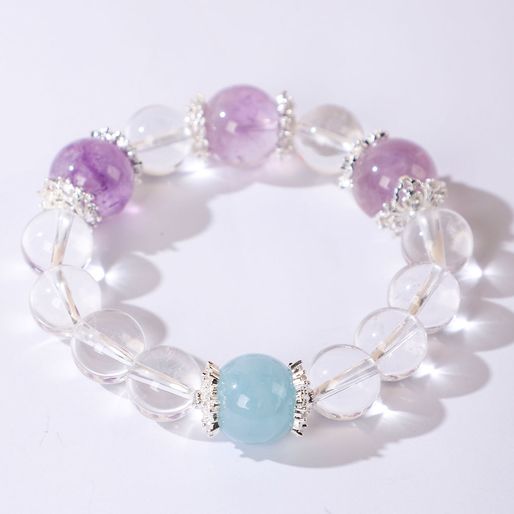 Minimalist crystal bracelet with three purple beads and one blue bead