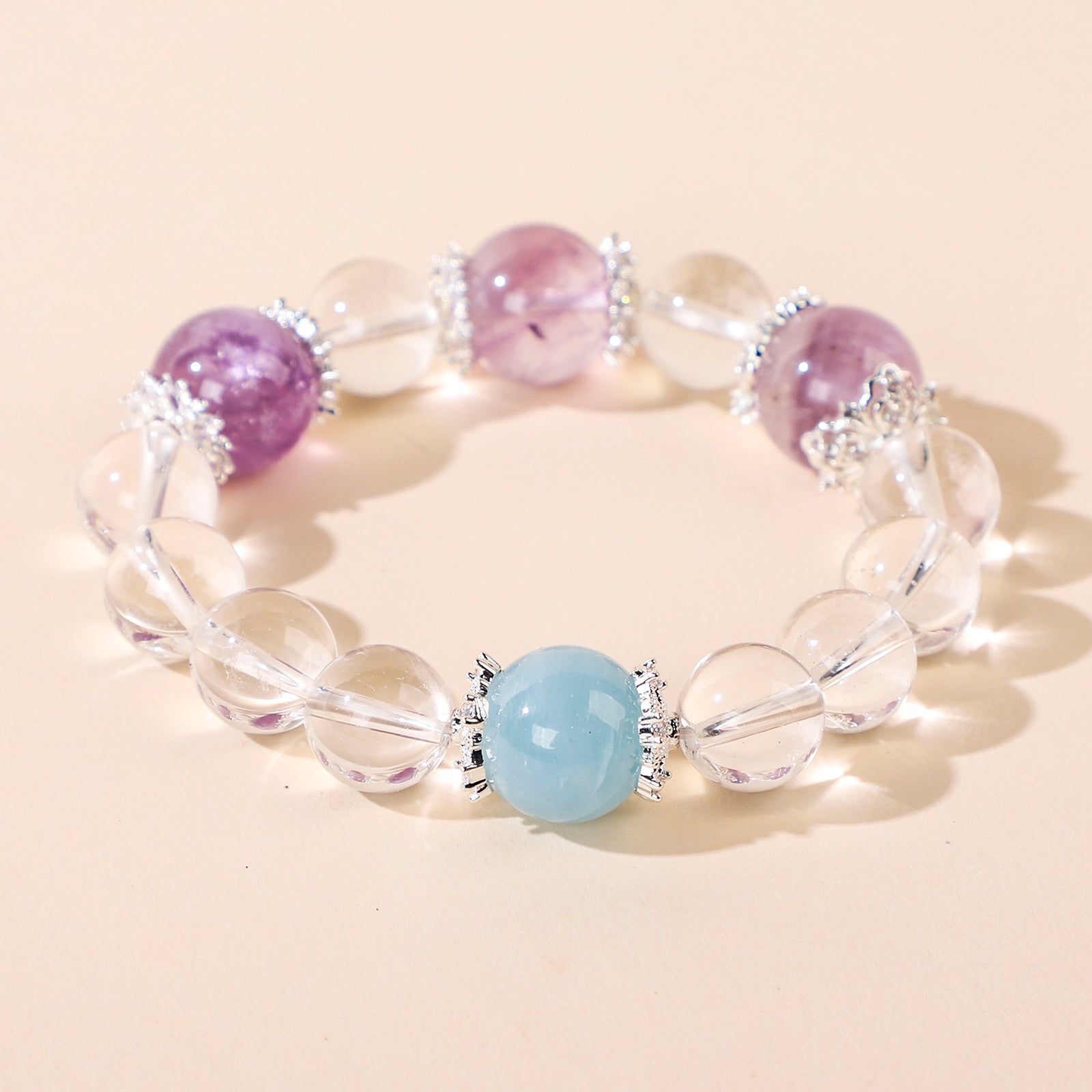 Minimalist crystal bracelet with three purple beads and one blue bead