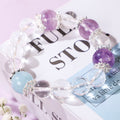 Minimalist crystal bracelet with three purple beads and one blue bead