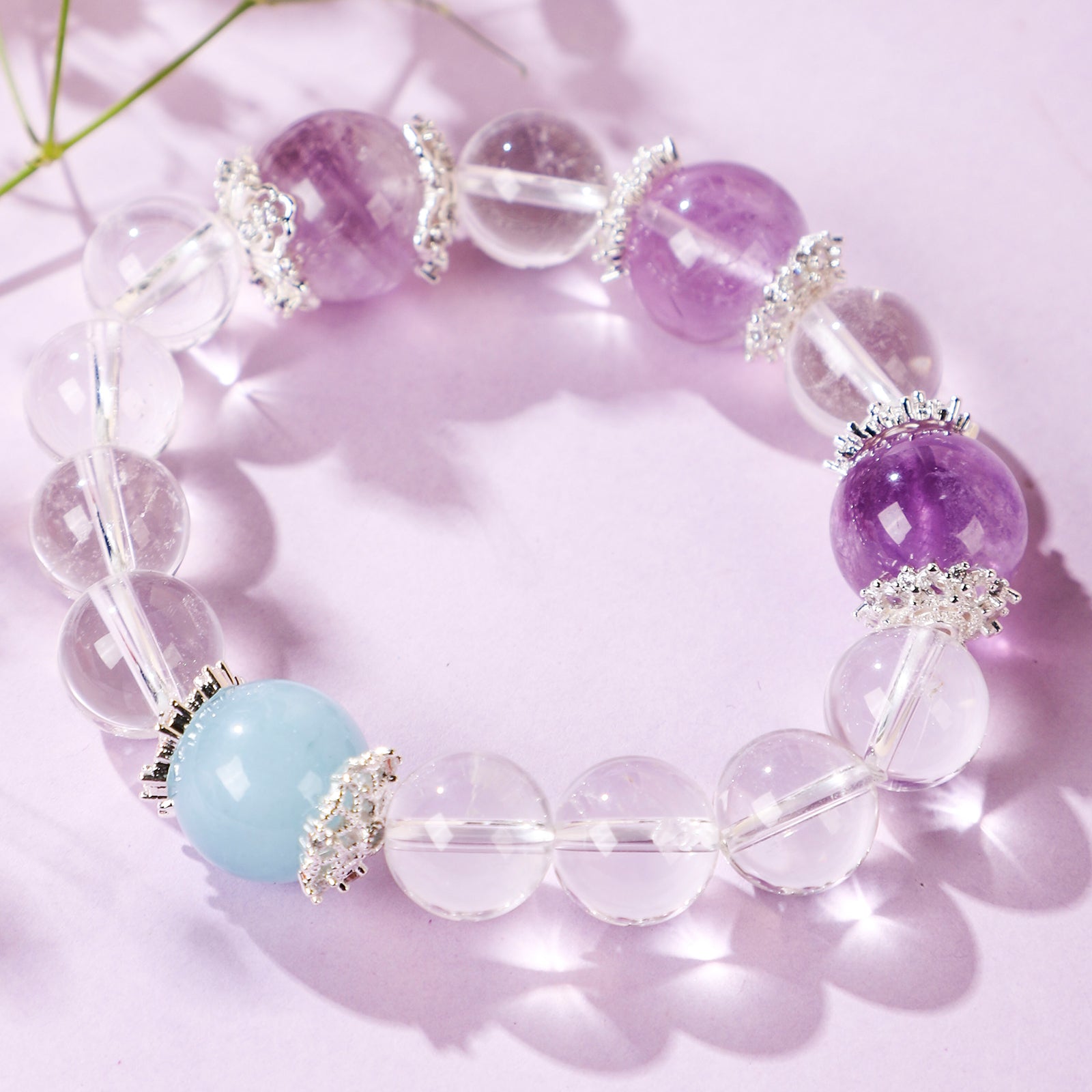 Minimalist crystal bracelet with three purple beads and one blue bead