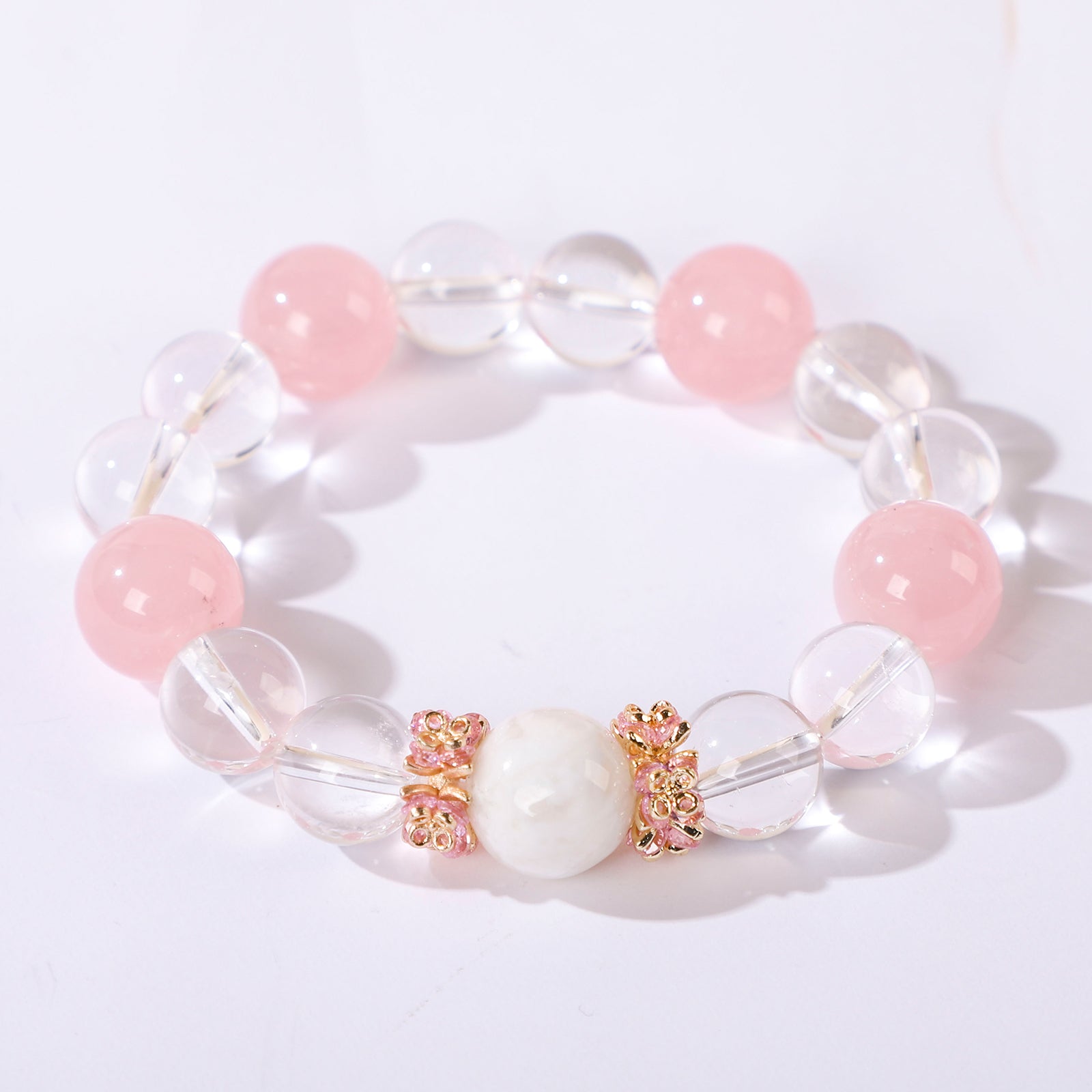Minimalist bracelet featuring four pink beads and white crystal beads